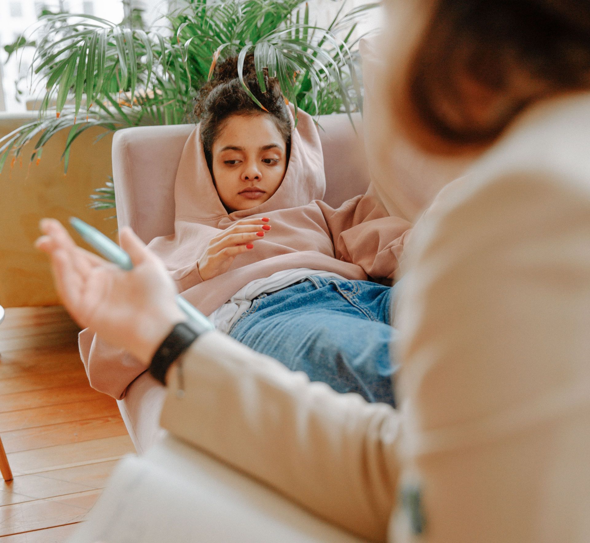 A teenager receiving counseling on a sofa with a therapist, creating a warm and supportive atmosphere.